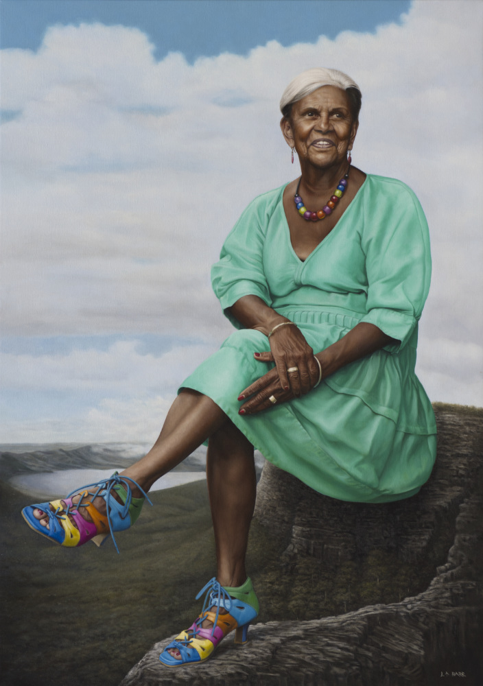 Portrait of Pamela Pedersen sitting on a vast landscape